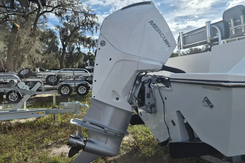 Slide: The Image of 2026 Defiance Catalina 240 boat with Mercury outboard motor in a trailer setting. - 20