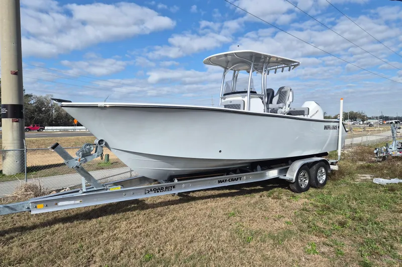 Slide: The Image of 2026 Defiance Catalina 240 boat on trailer, parked outdoors under a blue sky. - 3