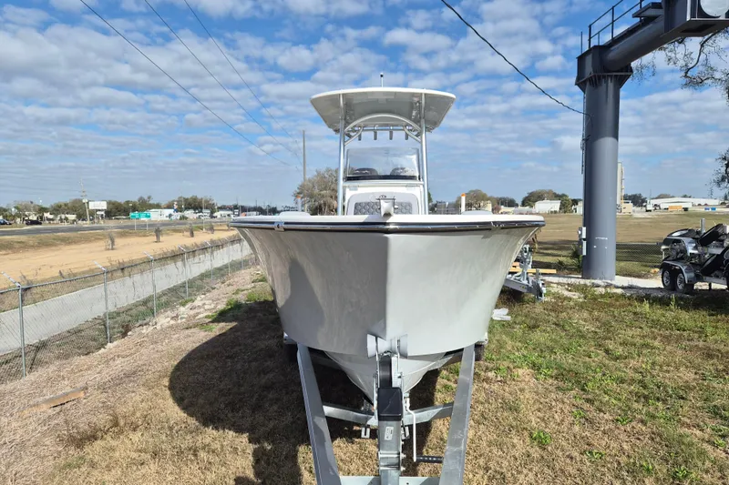 Slide: The Image of 2026 Defiance Catalina 240 boat on trailer, parked outdoors under a partly cloudy sky. - 4