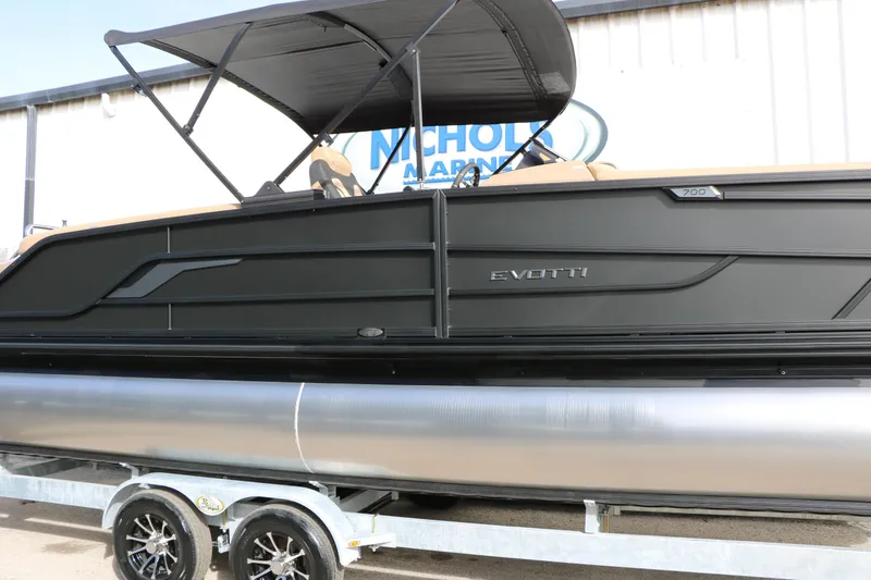 Slide: The Image of 2026 Evotti 725QL pontoon boat with sleek black design and canopy on trailer. - 13