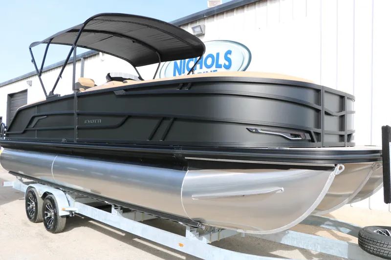 Slide: The Image of 2026 Evotti 725QL pontoon boat on trailer, sleek black design, outdoor setting. - 3