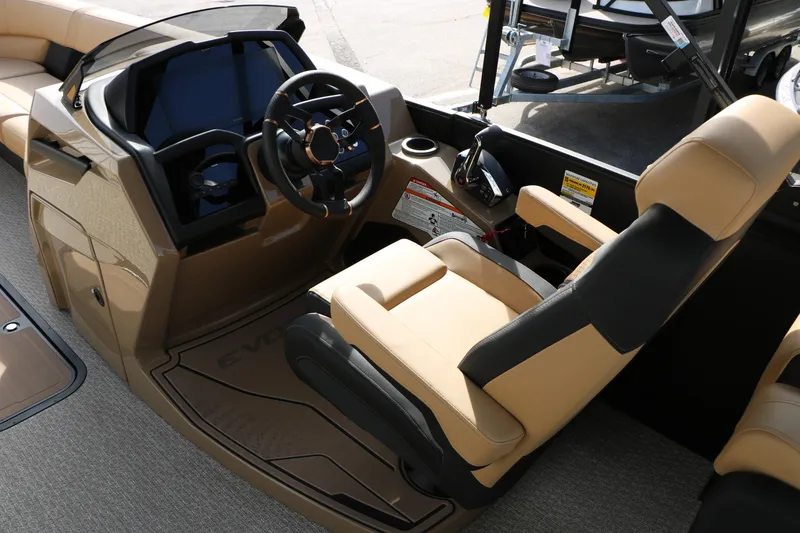 Slide: The Image of Captain's seat and helm of 2026 Evotti 725QL boat, featuring modern controls and beige upholstery. - 38