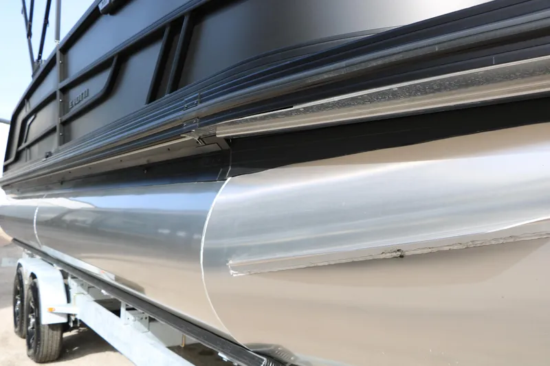 Slide: The Image of 2026 Evotti 725QL pontoon boat on trailer, showcasing sleek aluminum hull design. - 57