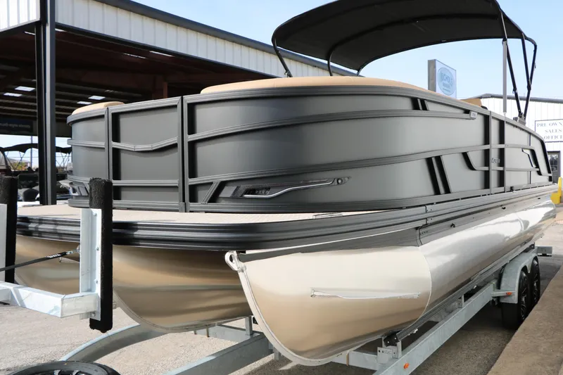Slide: The Image of 2026 Evotti 725QL pontoon boat on trailer, sleek design, outdoor setting. - 7