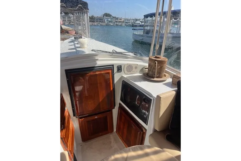 Slide: The Image of Interior of a 2002 Duffy Classic 21 boat with wooden cabinetry and marina view. - 4