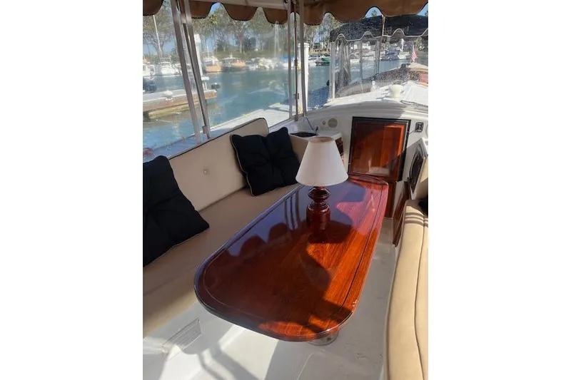 Slide: The Image of Interior of 2002 Duffy Classic 21 boat with polished wood table and lamp. - 6