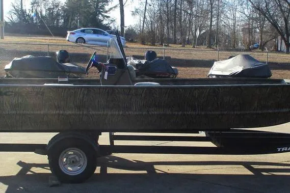Slide: The Image of 2026 Tracker Grizzly 2072 CC boat on trailer, parked outdoors. - 10