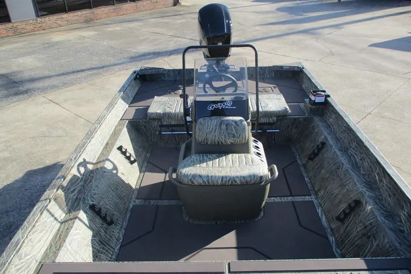 Slide: The Image of 2026 Tracker Grizzly 2072 CC boat with camouflage interior and central console. - 6