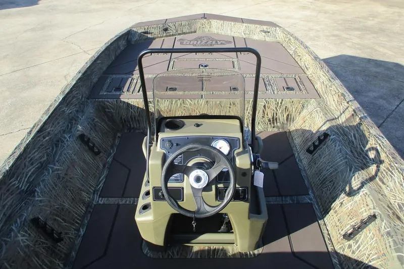 Slide: The Image of 2026 Tracker Grizzly 2072 CC boat interior with camouflage design and steering console. - 7