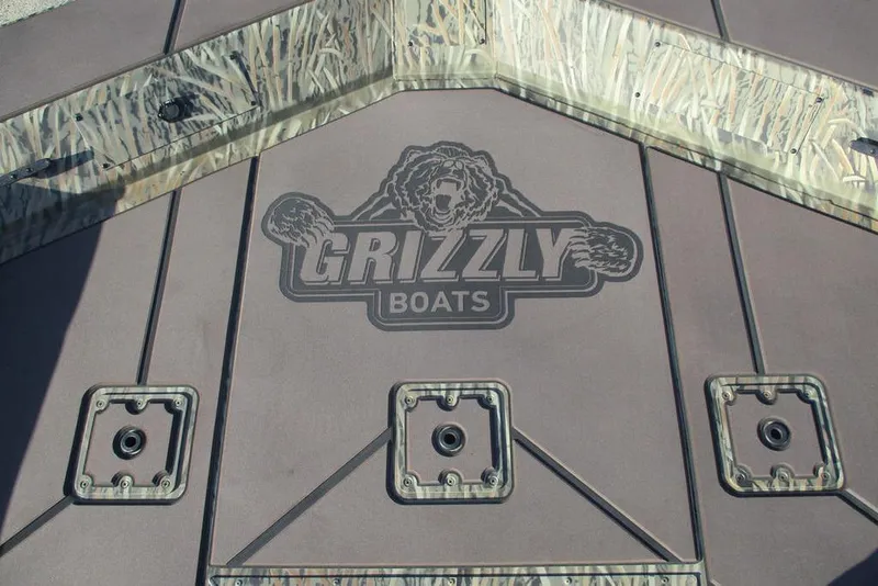 Slide: The Image of Deck of 2026 Tracker Grizzly 2072 CC boat with logo and camouflage design. - 9