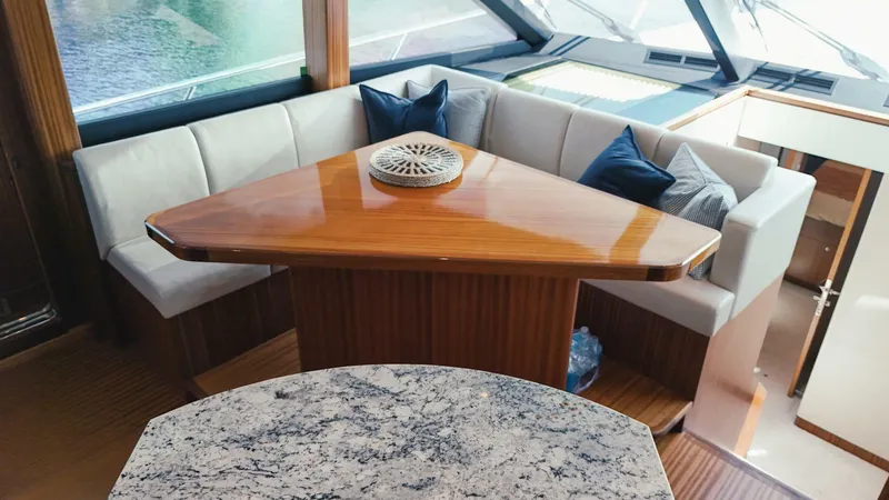 Slide: The Image of Luxurious interior of 2015 Ocean Alexander 72 yacht with elegant seating and wooden table. - 12