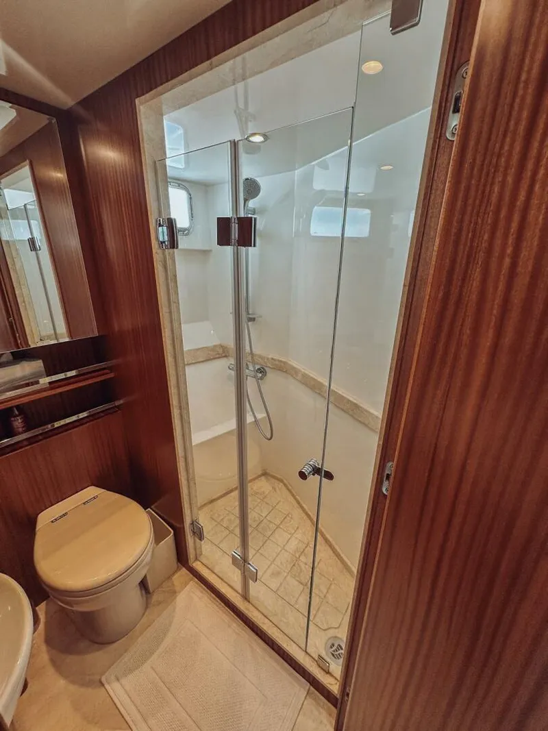 Slide: The Image of Luxurious bathroom in 2015 Ocean Alexander 72 yacht with glass shower and wooden accents. - 14