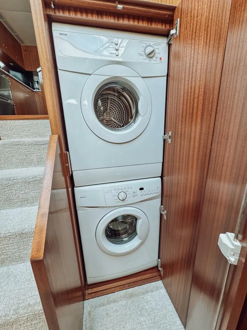 Slide: The Image of Stacked washer and dryer in 2015 Ocean Alexander 72 yacht's wooden cabinet. - 16