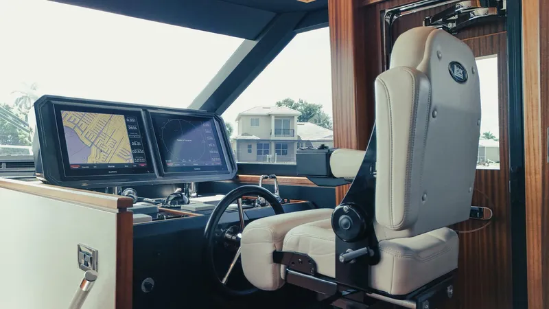 Slide: The Image of Helm of 2015 Ocean Alexander 72 yacht with navigation screens and captain's chair. - 17