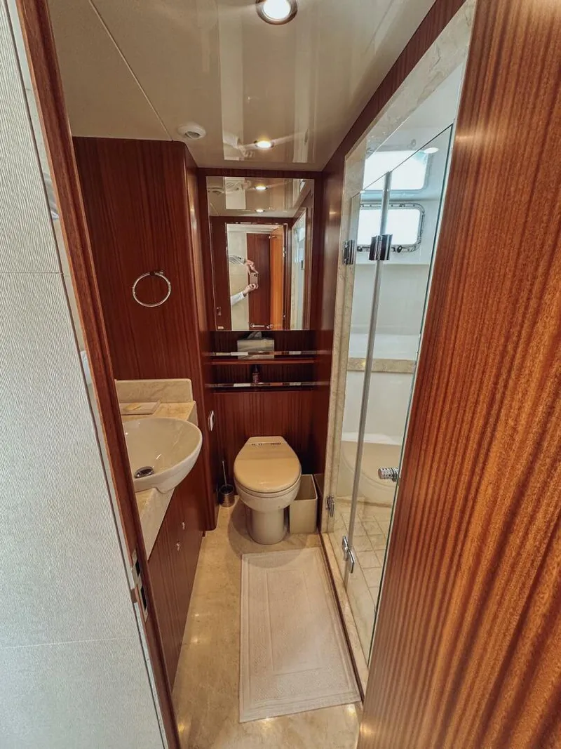 Slide: The Image of Luxurious bathroom in 2015 Ocean Alexander 72 yacht with wood accents and modern fixtures. - 18