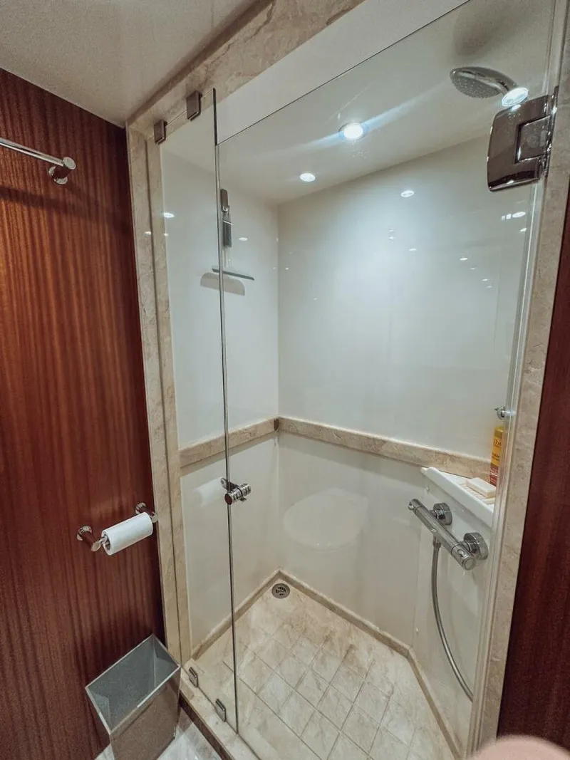 Slide: The Image of Luxurious shower in 2015 Ocean Alexander 72 yacht, featuring glass door and elegant wood paneling. - 23