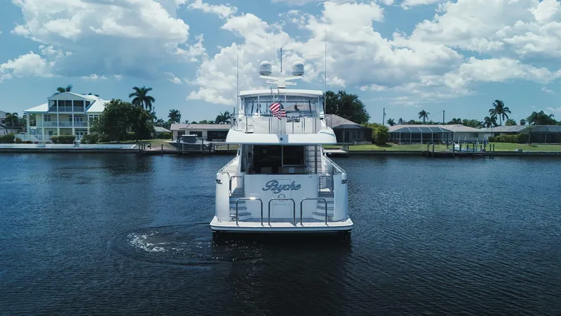 Slide: The Image of Luxury yacht Ocean Alexander 72, 2015 model, cruising on a sunny day with waterfront homes in the background. - 26