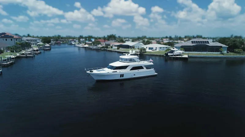 Slide: The Image of Luxurious 2015 Ocean Alexander 72 yacht cruising in a serene residential canal. - 5