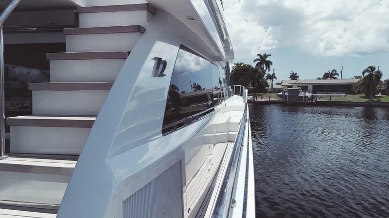 Slide: The Image of Luxury Ocean Alexander 72 yacht, 2015 model, docked by a serene waterfront. - 6