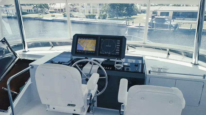 Slide: The Image of Helm of 2015 Ocean Alexander 72 yacht with navigation screens and steering wheel. - 7