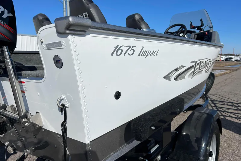 Slide: The Image of 2016 Lund 1675 Impact Sport boat interior with four seats and Mercury engine. - 14