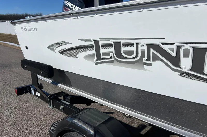 Slide: The Image of 2016 Lund 1675 Impact Sport boat, white exterior, parked on a trailer. - 15