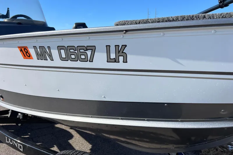 Slide: The Image of 2016 Lund 1675 Impact Sport boat with registration sticker, side view. - 18