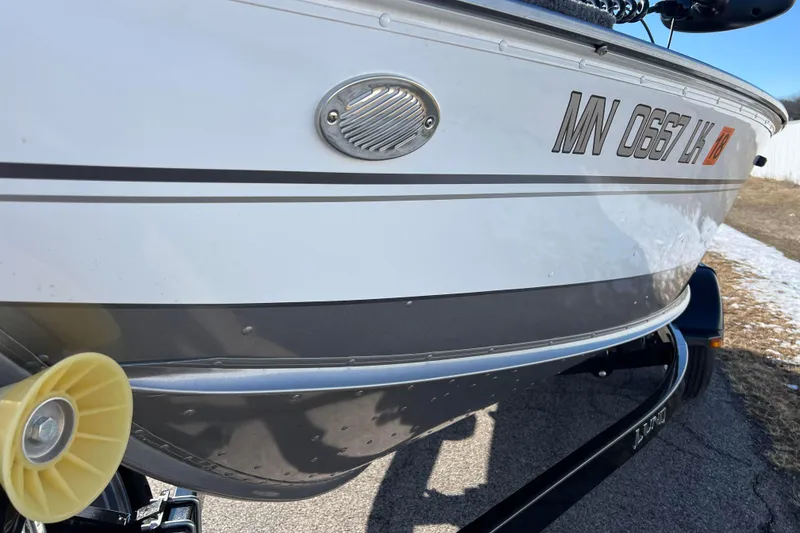 Slide: The Image of 2016 Lund 1675 Impact Sport boat on trailer, close-up of bow and roller. - 20