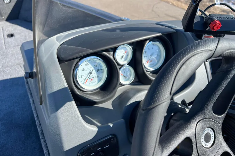 Slide: The Image of Control panel of a 2016 Lund 1675 Impact Sport boat with audio system and switches. - 31