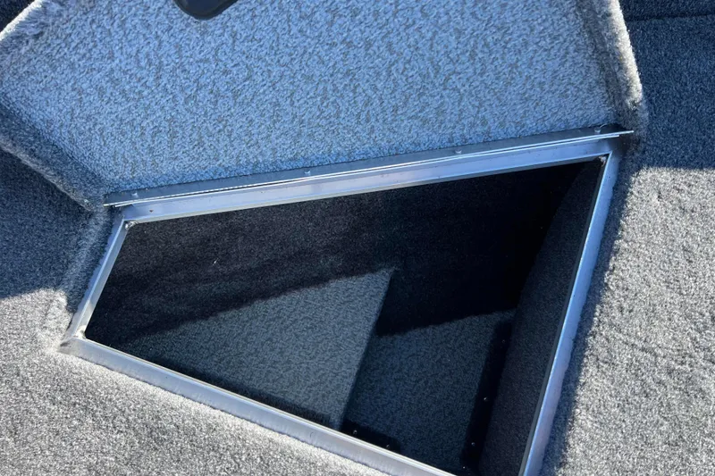 Slide: The Image of 2016 Lund 1675 Impact Sport boat interior with black cover and motor. - 34