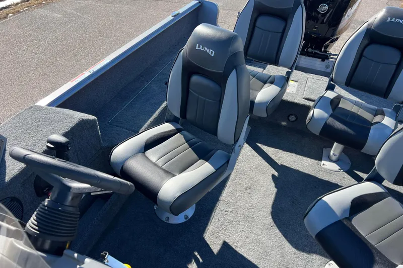 Slide: The Image of 2016 Lund 1675 Impact Sport boat interior with gray and black seating. - 40