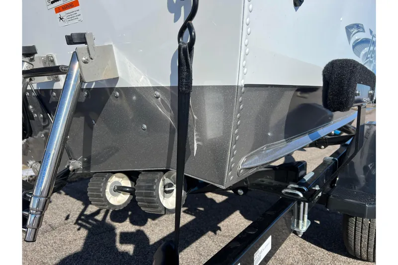 Slide: The Image of 2016 Lund 1675 Impact Sport boat on trailer, close-up view of hull and wheels. - 48