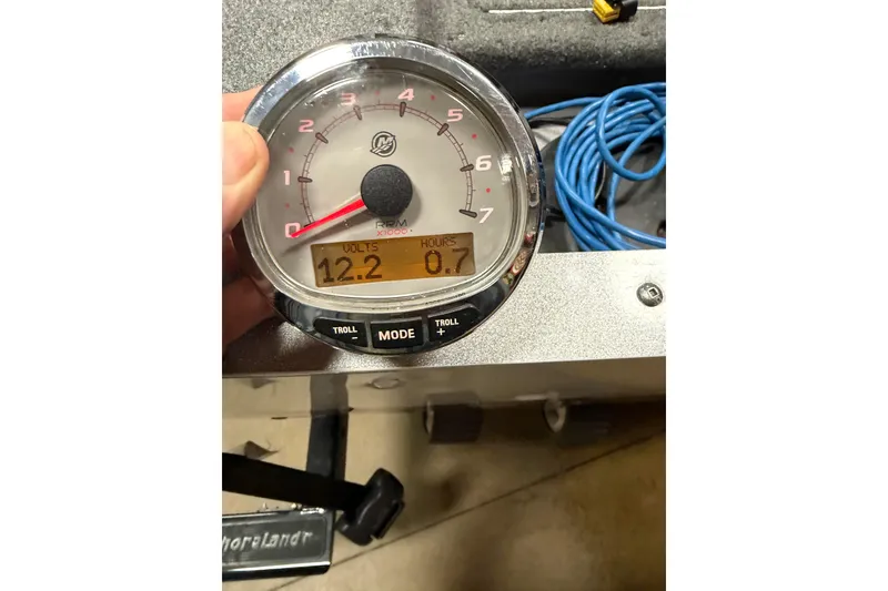 Slide: The Image of 2016 Lund 1675 Impact Sport boat on trailer with Mercury engine, parked outdoors. - 5