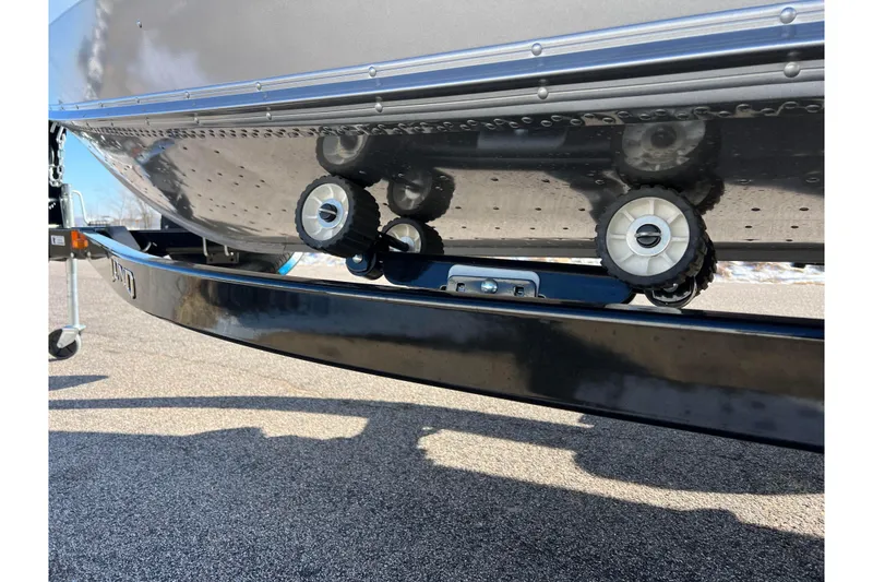 Slide: The Image of 2016 Lund 1675 Impact Sport boat on trailer, close-up of hull and wheels. - 50