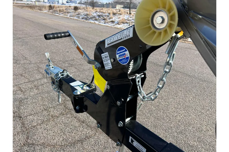 Slide: The Image of 2016 Lund 1675 Impact Sport boat trailer with rollers on pavement. - 51