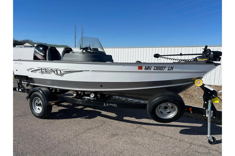 Slide: The Image of Manufacturer Provided Image: 2016 Lund 1675 Impact Sport boat on water with person fishing. - 54