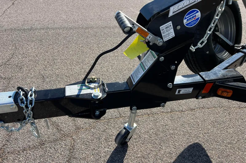 Slide: The Image of 2016 Lund 1675 Impact Sport boat on trailer, parked on a sunny road. - 7