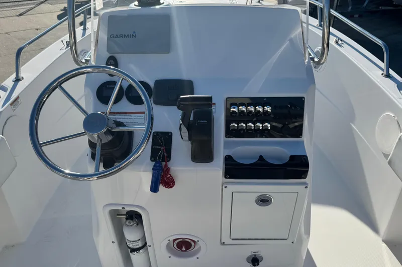 Slide: The Image of 2019 Edgewater 188CC boat console with steering wheel and Garmin navigation system. - 3