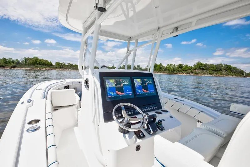 Slide: The Image of 2027 Buddy Davis 28 Center Console boat on water, featuring modern navigation displays. - 6