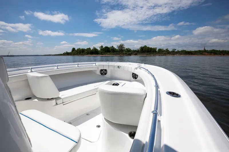 Slide: The Image of 2027 Buddy Davis 28 Center Console boat interior with white seating on a sunny day. - 7