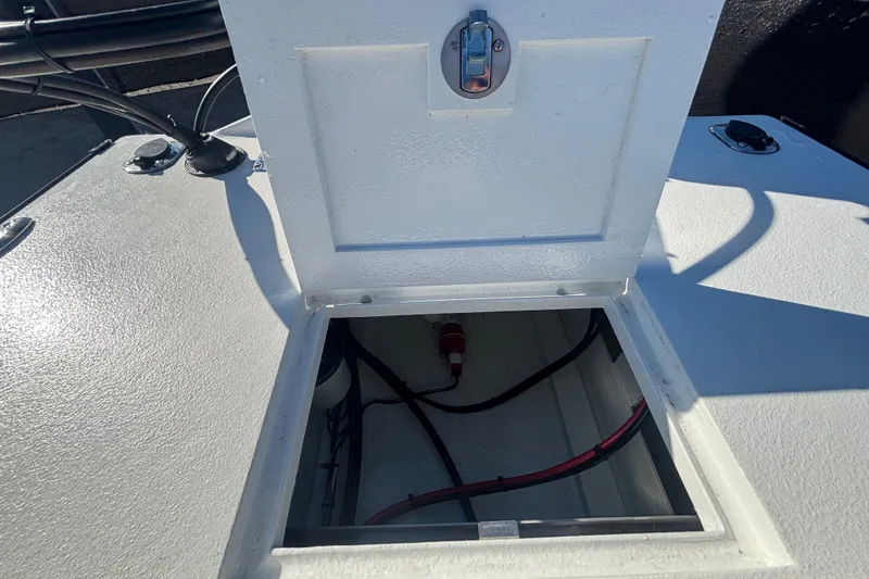Slide: The Image of Open hatch on Custom FS 14 boat, revealing interior wiring, 2025 model. - 22
