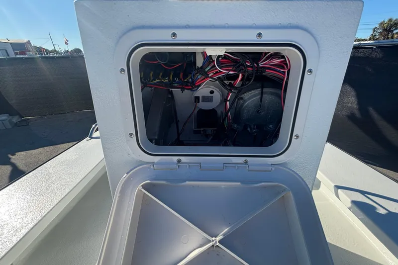 Slide: The Image of Open hatch of Custom FS 14 boat, revealing internal wiring and components, 2025 model. - 28