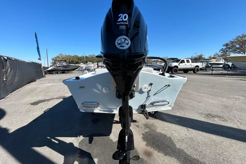 Slide: The Image of Custom FS 14 boat, 2025 model, with a 20 HP outboard motor in a marina setting. - 3