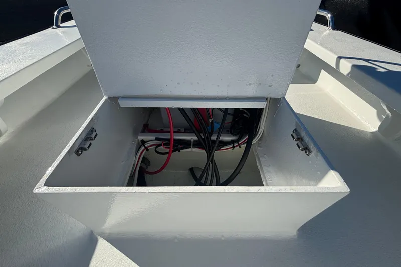 Slide: The Image of Open storage compartment on Custom FS 14 boat, showing internal wiring, 2025 model. - 31