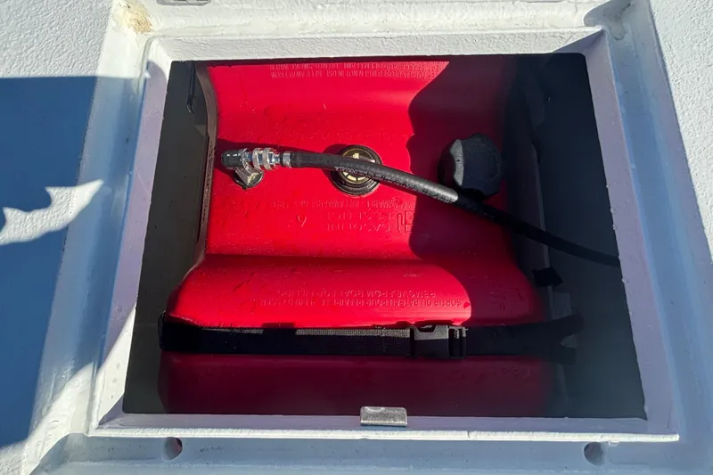 Slide: The Image of Red fuel tank in a Custom FS 14, 2025 model, secured in a white compartment. - 35
