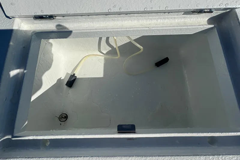 Slide: The Image of Open storage compartment in Custom FS 14, 2025 model, with tubing and latch. - 38