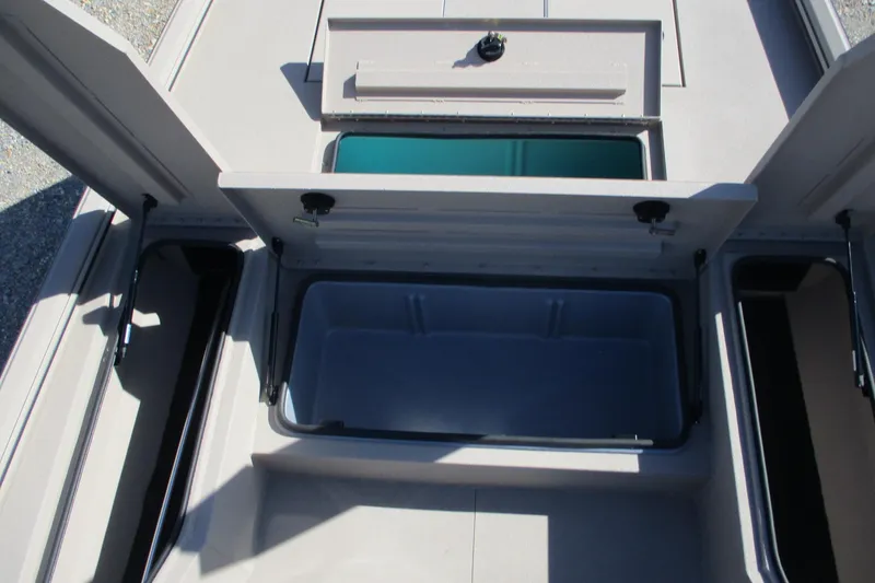 Slide: The Image of Open storage compartments on 2026 Avid 207 Recon boat deck. - 10