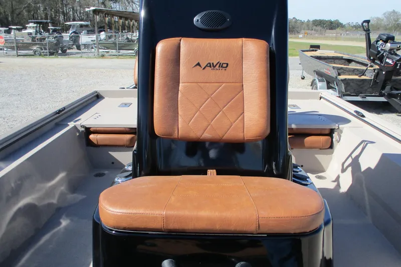 Slide: The Image of Avid 207 Recon 2026 boat with tan leather seating in a sunny outdoor setting. - 12
