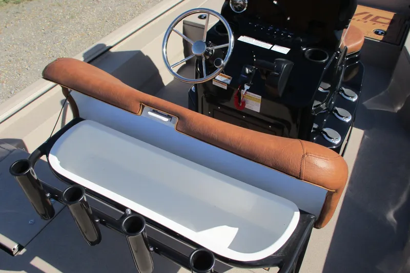 Slide: The Image of Interior of 2026 Avid 207 Recon boat with steering wheel and seating area. - 14