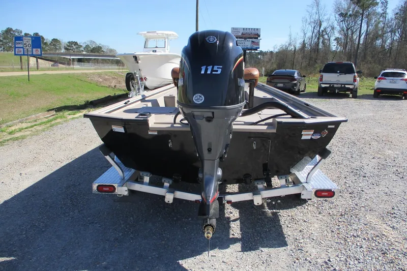Slide: The Image of Avid 207 Recon 2026 boat with Yamaha 115 engine on a trailer in a parking lot. - 6